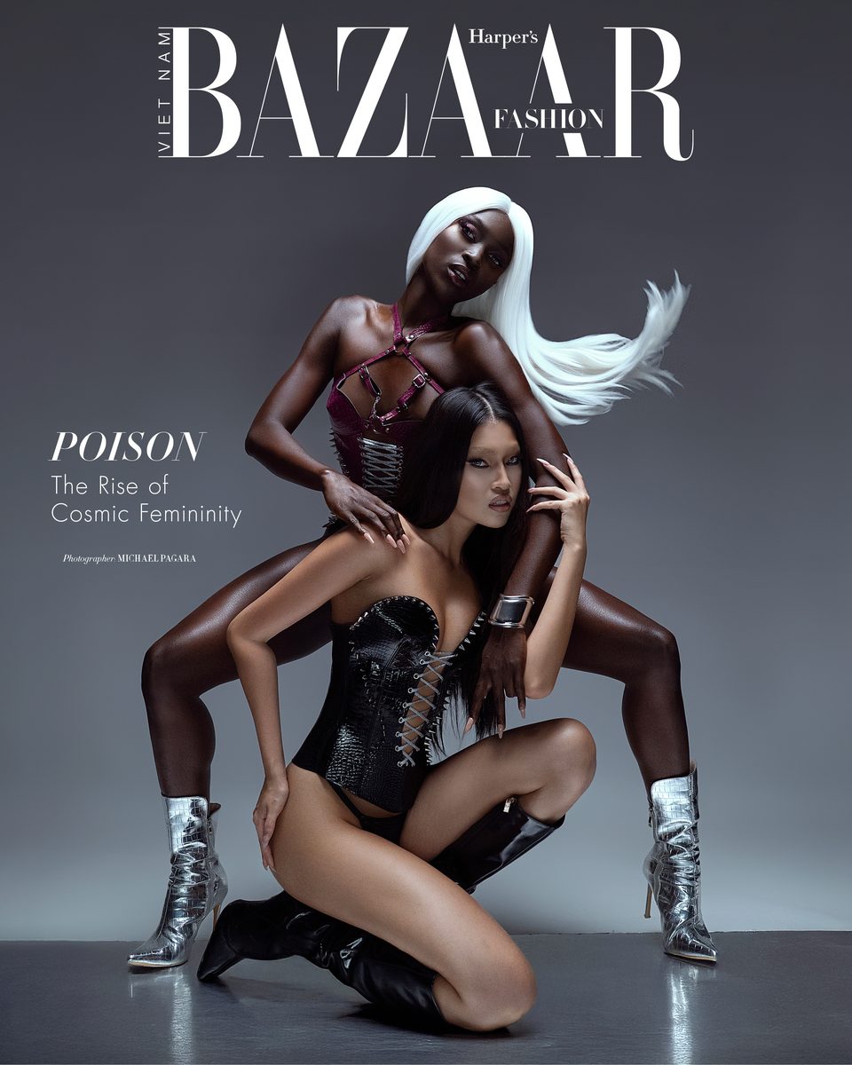 Harper's Bazaar cover story: two models in corsetry and metallic boots against a grey backdrop.