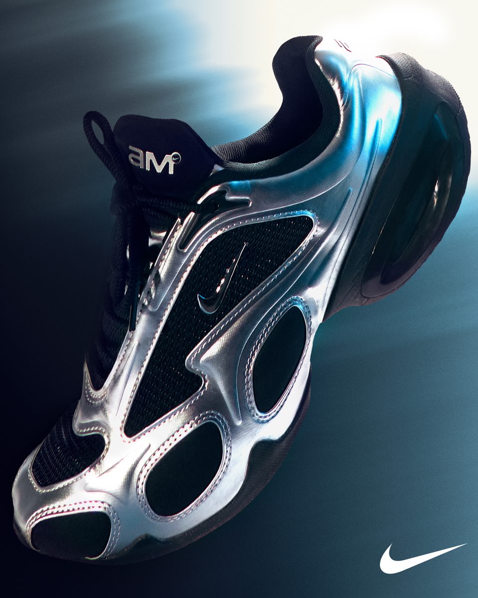 A chrome Nike sneaker photographed against a deep blue gradient.